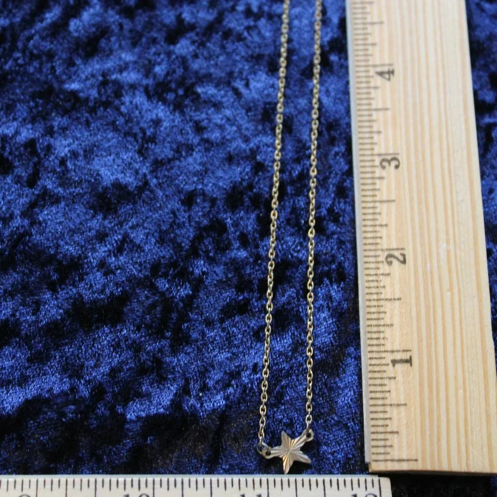 Silver toned necklace with star